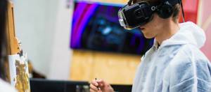 un homme qui peint avec un casque de réalité virtuelle