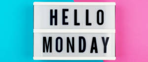 Un panneau "Hello Monday" sur fond rose et bleu