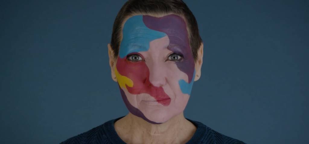 Une femme avec un maquillage coloré sur le visage