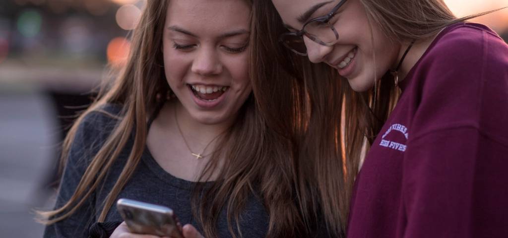 Deux adolescentes qui regardent un smartphone