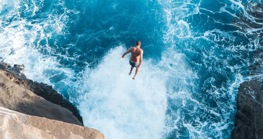 Homme sautant dans la mer