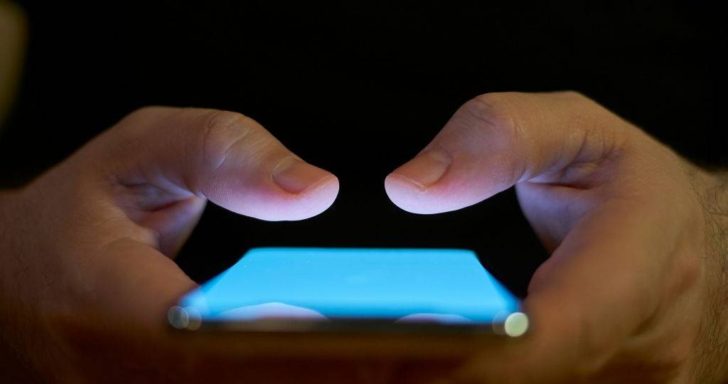 Mains tenant un smartphone