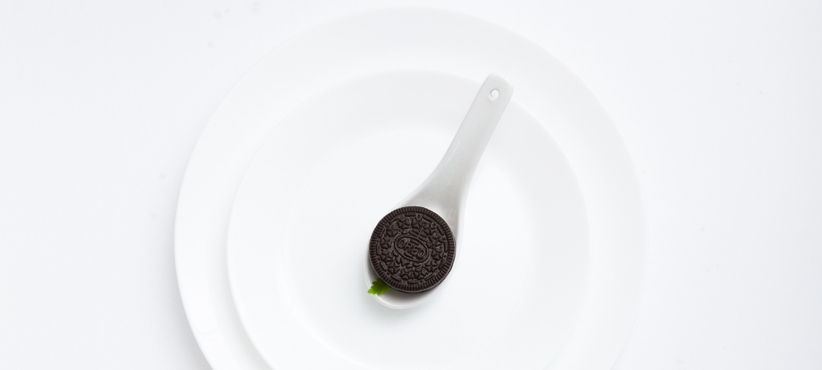 Mondelez va produire des biscuits au cannabis Biscuit Oreo placé dans une assiette blanche, sur fond blanc minimaliste