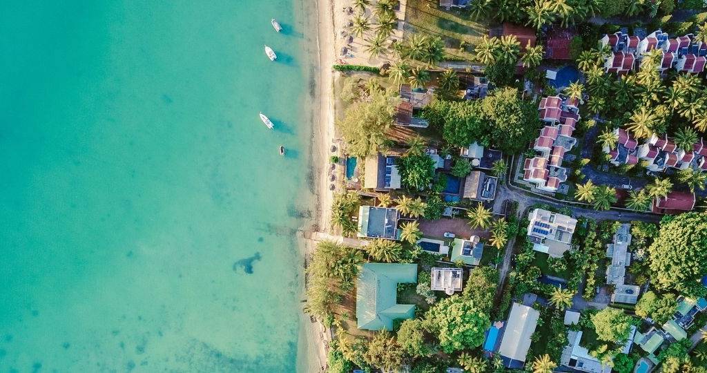 Vue du ciel d'une île tropical. Des villas et des bateaux sur une eau translucide