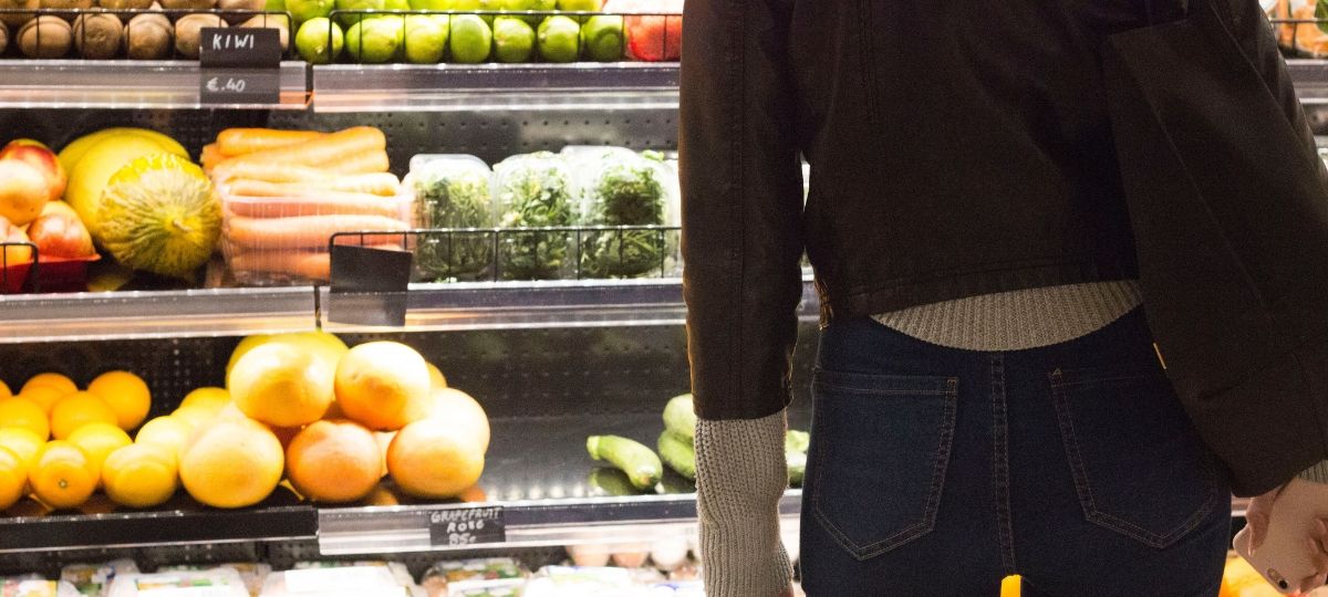 Carrefour se retire de Chine, grignoté par l’effet Amazon Une jeune femme se tient de dos devant un rayon de surperché