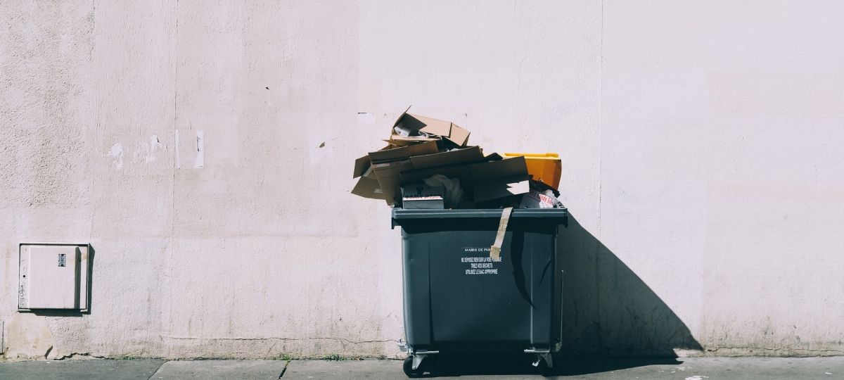 Le gouvernement oblige les fast-food a (vraiment)trier leurs déchets Une benne à ordure noir, contre un mur clair