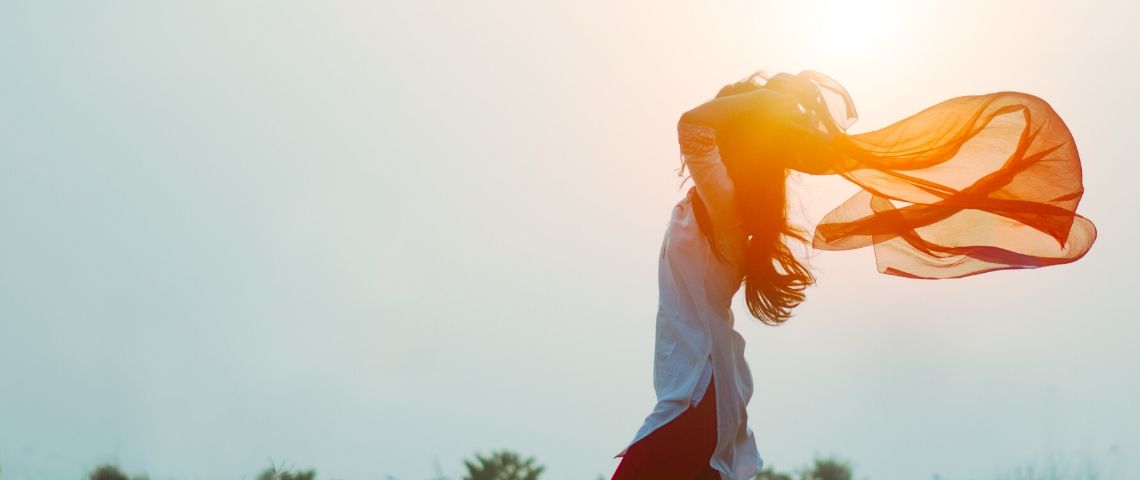 Etam, Darjeeling et Auchan se mettent aux culottes menstruelles Viusle d'une femme les bras en l'air au soleil levant
