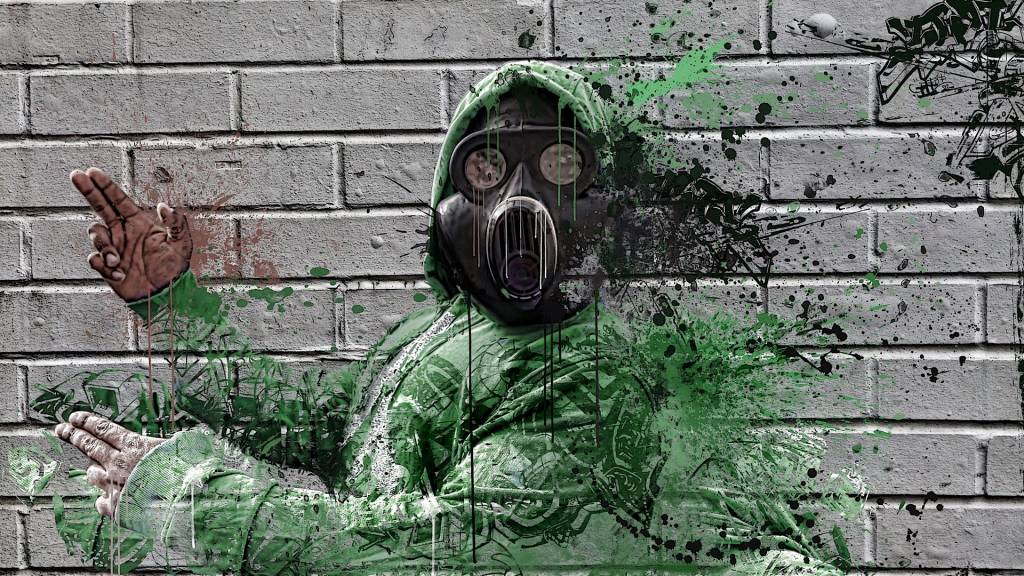 graffiti d'un homme se désagrégent et portant un masque à gat