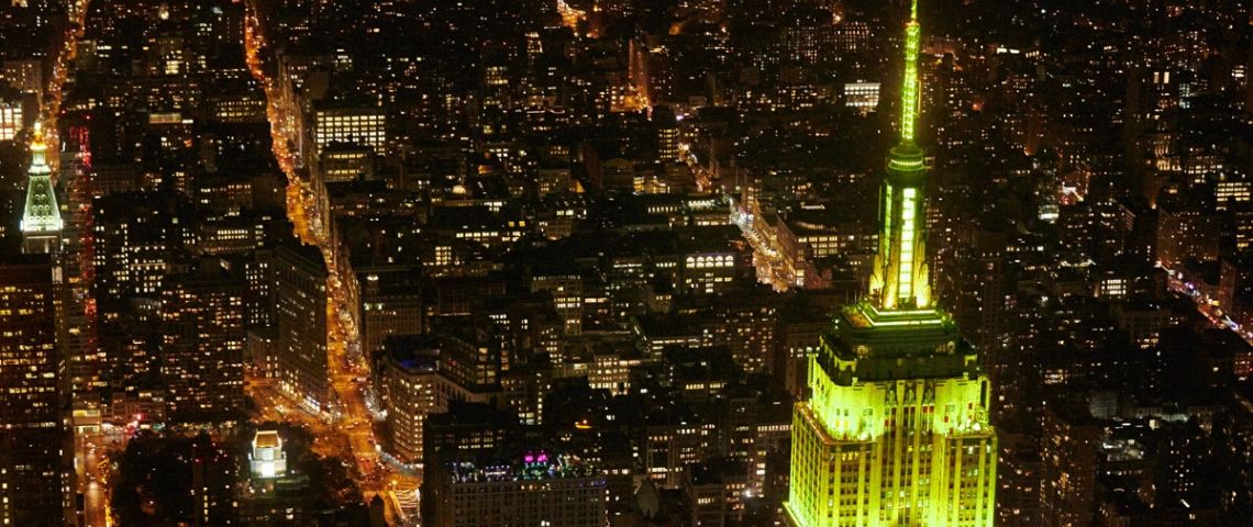 Empire state building de nuit illuminé en jaune