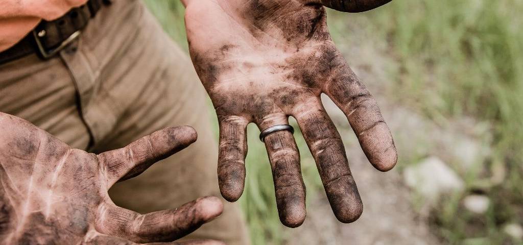 Mains d'agriculteur pleine de terre