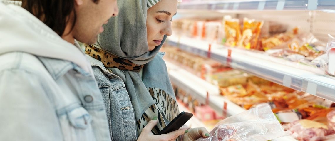 Dix acteurs de l’alimentation lancent un nouveau logo pour mesurer l'impact environnemental d’un produit : l’éco-score Couple regardant une étiquette dans un supermarché