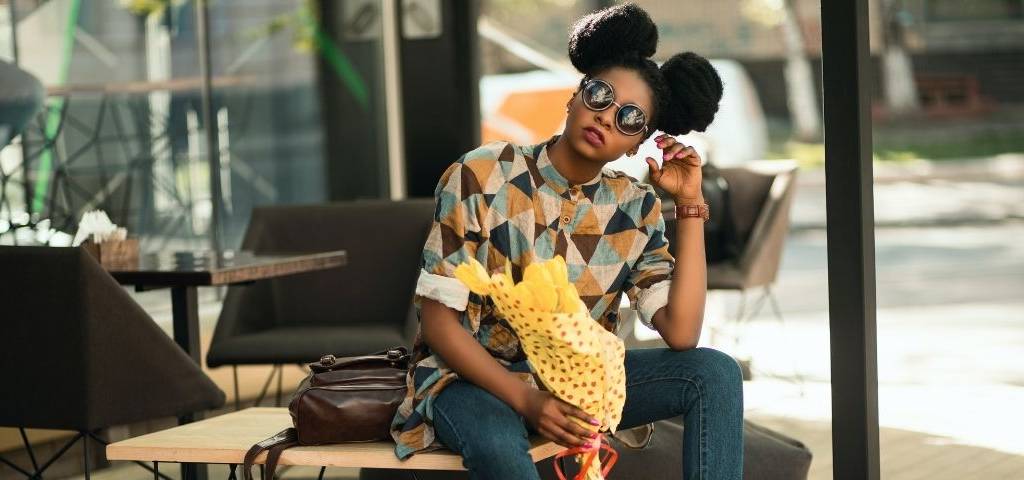 Jeune femme assise avec un bouquet de fleurs jaunes