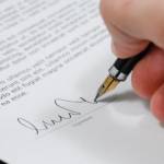 Main signant une feuille