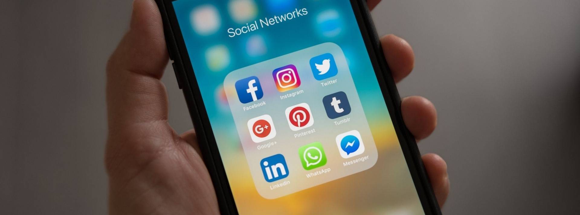 Emplifi lance sa plateforme Social Commerce Cloud pour offrir des fonctionnalités de commerce social et service client aux équipes marketing et e-commerce. Smartphone avec le logo des principaux réseaux sociaux