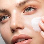 Femme s'étalant de la crème sur le visage