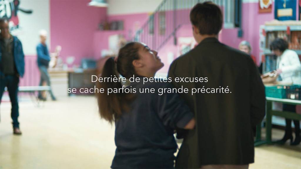 jeune bénévole des restos du coeur accueillant un jeune homme