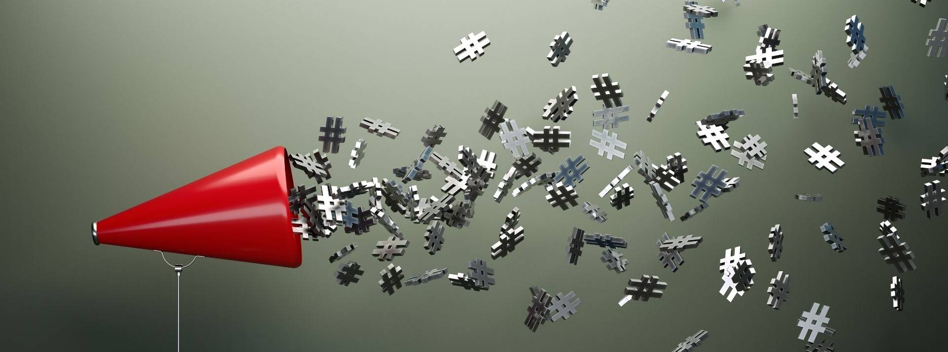Visibrain dresse le bilan des sujets qui ont marqué les Français sur Twitter cette année. Mégaphone rouge et hashtag argent symboles devant de mur gris