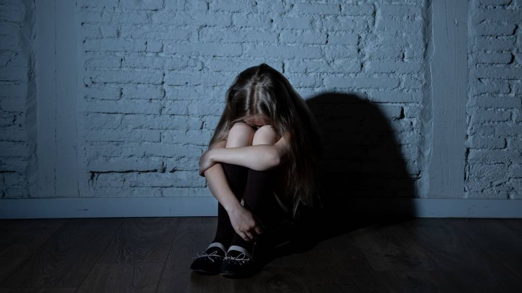 Jeune fille recroquevillée sur elle même