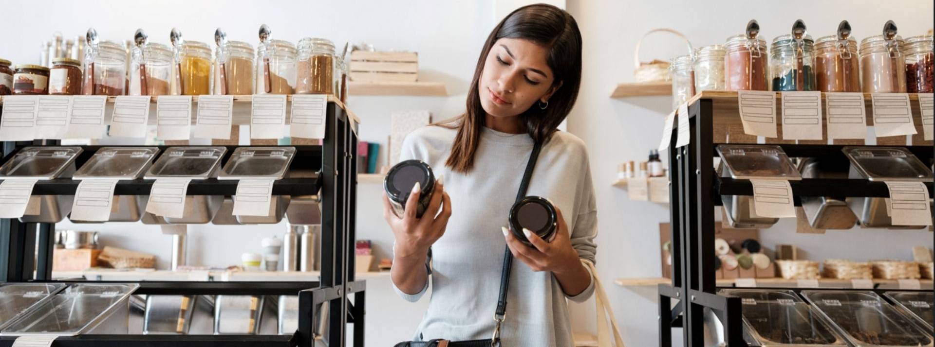 Etude « Sustainability Trends 2022 » Kantar Insights : pour les consommateurs, la décroissance n’est pas un sujet tabou Femme comparant deux pots dans un magasin