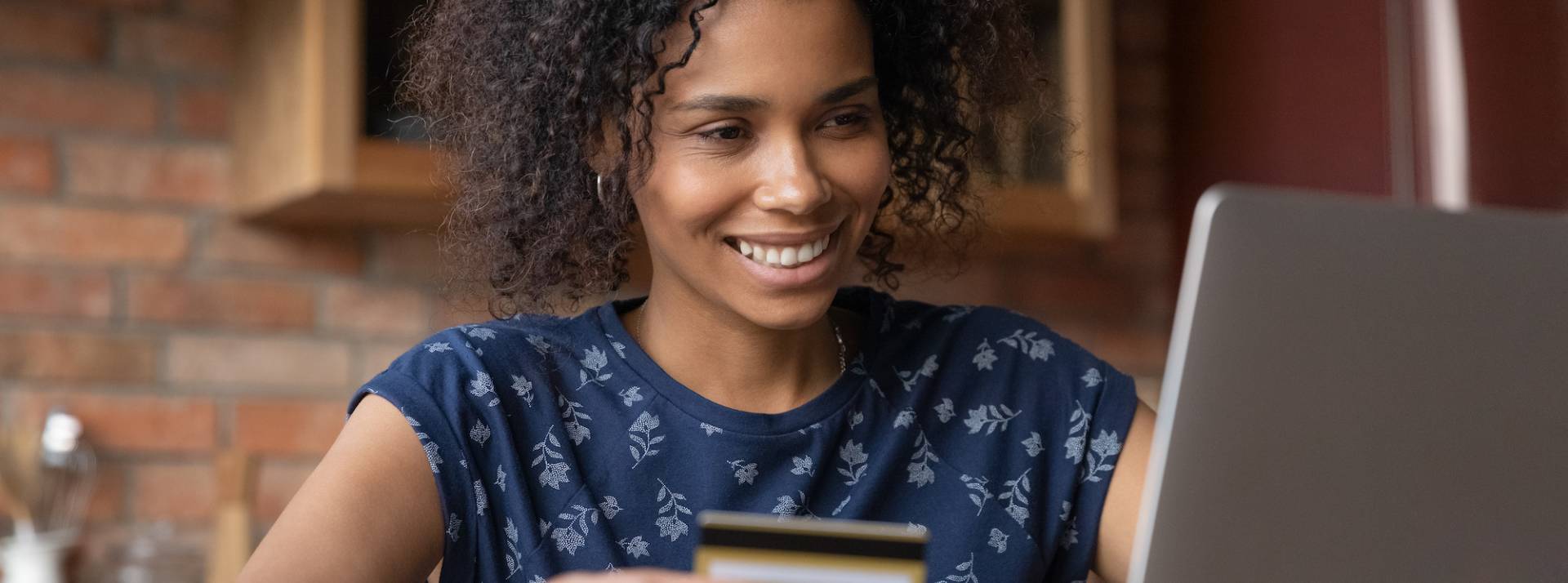 Happy biracial female buy goods at internet using gold card Happy biracial female buy goods at internet using gold card